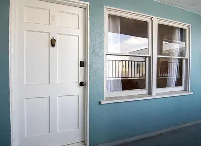 a white door and a window on a blue wall at Affordable One-Bedroom Close to Pico and Beverly Hills in Los Angeles