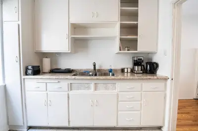 a kitchen with white cabinets and a sink at Affordable One-Bedroom Close to Pico and Beverly Hills in Los Angeles