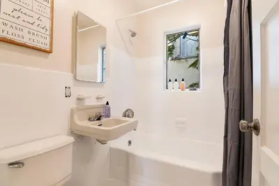 a white bathroom with a sink and a toilet and a window at Affordable One-Bedroom Close to Pico and Beverly Hills in Los Angeles