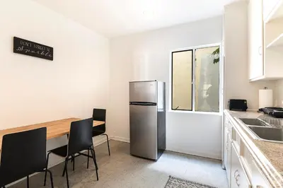a kitchen with a refrigerator and a table and chairs at Affordable One-Bedroom Close to Pico and Beverly Hills in Los Angeles