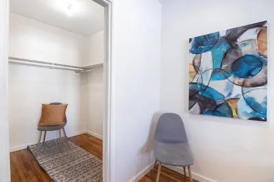a hallway with two chairs and a painting on the wall at Bright Second-Floor Studio Near Beverly Hills in Los Angeles