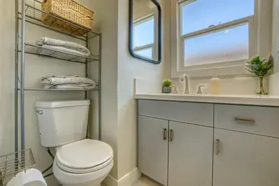 a bathroom with a toilet and a sink and a mirror at Southbaysunshine coastal Villa by beach-30 plus Days in Torrance