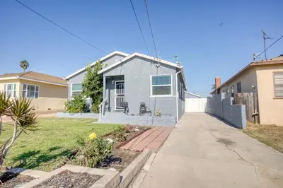 a house with a dog sitting in the front yard at Southbaysunshine coastal Villa by beach-30 plus Days in Torrance
