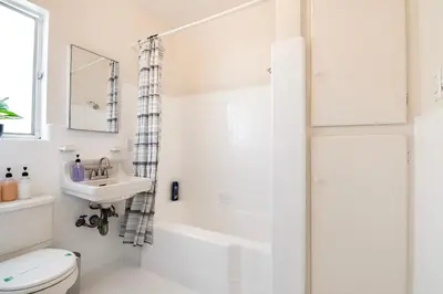 a white bathroom with a toilet and a sink at Comfortable 1B 2beds Retreat Near Beverly Hills in Los Angeles