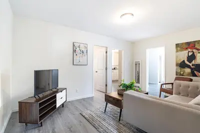 a living room with a couch and a flat screen tv at Comfortable 1B 2beds Retreat Near Beverly Hills in Los Angeles
