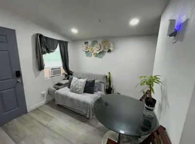a living room with a glass table and a couch at Hidden Gem in San Bernardino