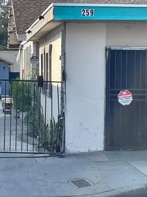 a garage with a door with a sign on it at Hidden Gem in San Bernardino