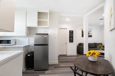 a kitchen with a table with a vase of flowers at Comfortable 2Bedroom apartment close to Beverly Hills in Los Angeles