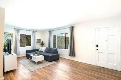 a living room with a couch and a tv at Comfortable One-Bedroom with Two Queen Beds in Los Angeles