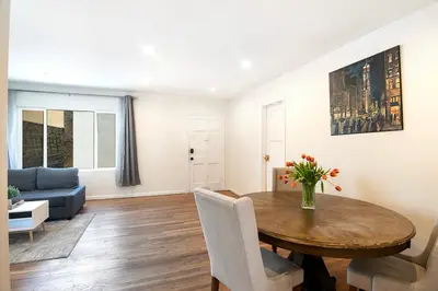 a living room with a table and a couch at Comfortable One-Bedroom with Two Queen Beds in Los Angeles