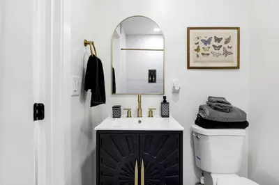 a bathroom with a sink and a mirror and a toilet at Family Retreat Near Disneyland & Downtown LA 4BR in Los Angeles