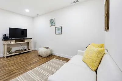 a living room with a white couch and a tv at Family Retreat Near Disneyland & Downtown LA 4BR in Los Angeles