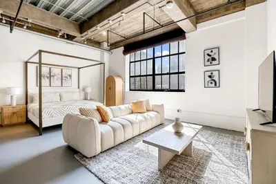 a living room with a couch and a bed at DTLA Boutique Loft w Rooftop Pool Hot Tub in Los Angeles