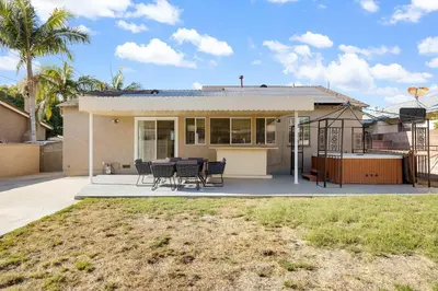 a house with a table and chairs in front of it at Family Oasis Near Disneyland & Knotts in Downey