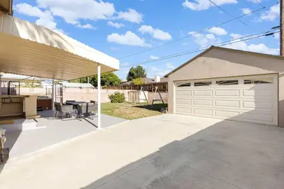 a house with a garage and a patio at Family Oasis Near Disneyland & Knotts in Downey