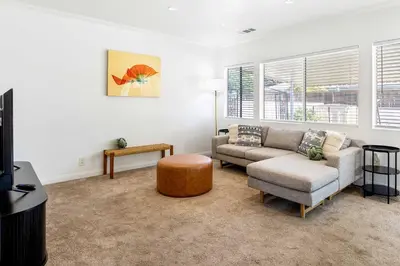 a living room with a couch and a table at Family Oasis Near Disneyland & Knotts in Downey
