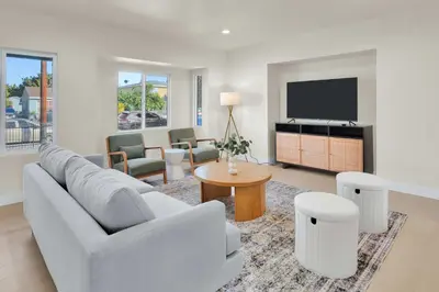 a living room with a couch and a tv at Stylish LA Retreat Near Disney Knotts SoFi in Paramount