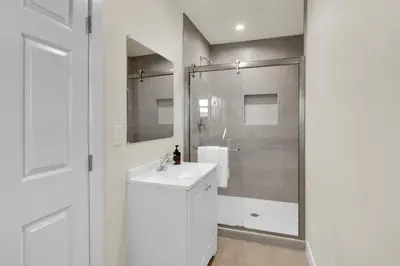 a white bathroom with a sink and a shower at Stylish LA Retreat Near Disney Knotts SoFi in Paramount