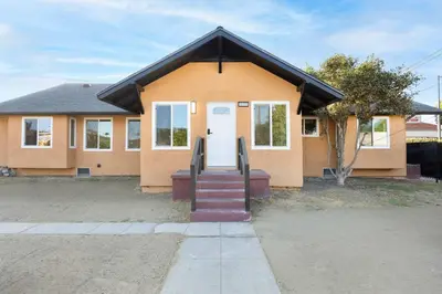 a house with a staircase leading to the front door at Stylish LA Retreat Near Disney Knotts SoFi in Paramount