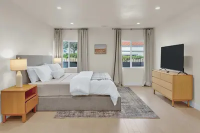 a bedroom with a bed with a dresser and a tv at Stylish LA Retreat Near Disney Knotts SoFi in Paramount