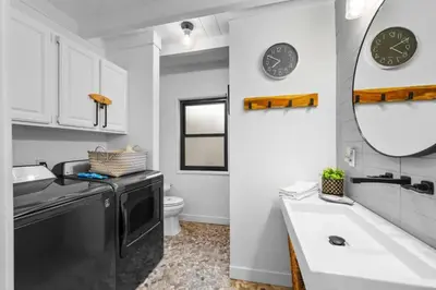 a bathroom with a sink and a black dishwasher at Luxe Beachside Escape Near Channel Islands in Oxnard