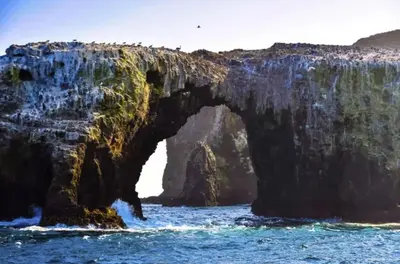an arch in a rock formation in the ocean at Luxe Beachside Escape Near Channel Islands in Oxnard