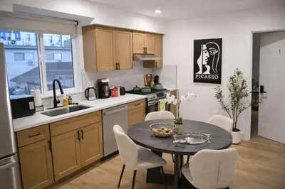 a kitchen with a table and chairs in a kitchen at Luxe Ensuite in Shared Home-Minutes to USC in Los Angeles