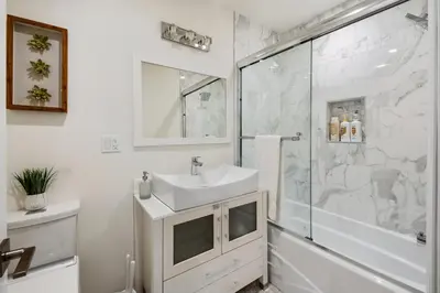 a bathroom with a sink and a shower at Charming Encino Retreat with Pool in Encino