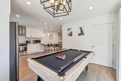 a pool table in the middle of a living room at Charming Encino Retreat with Pool in Encino
