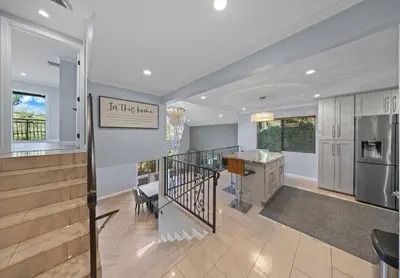 a living room with a staircase and a kitchen at Tranquil Hideaway Private Retreat with Mountain Views in Tujunga