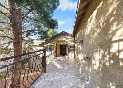 a walkway leading up to a building with a tree at Tranquil Hideaway Private Retreat with Mountain Views in Tujunga