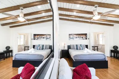 a bedroom with two beds and a couch at Cozy Beverly Hills Studio Near Shopping with Kitchen in Los Angeles