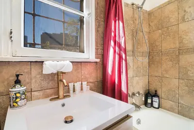 a bathroom with a white sink and a window at Cozy Beverly Hills Studio Near Shopping with Kitchen in Los Angeles