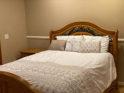 a bed with white sheets and pillows on it at Family Nature Retreat Near LA with Indoor Grotto Pool in Simi Valley