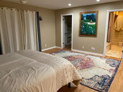 a bedroom with a bed and a rug at Family Nature Retreat Near LA with Indoor Grotto Pool in Simi Valley