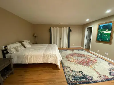 a bedroom with a bed and a large rug at Family Nature Retreat Near LA with Indoor Grotto Pool in Simi Valley