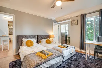 a bedroom with two beds with yellow pillows at Melrose Hill Home Near Hospitals Nurses Welcome! in Los Angeles
