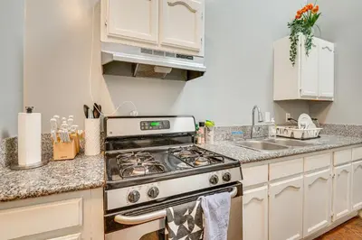 a kitchen with a stove and a sink at Melrose Hill Home Near Hospitals Nurses Welcome! in Los Angeles