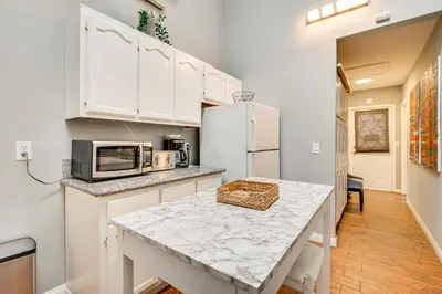 a kitchen with white cabinets and a counter top at Melrose Hill Home Near Hospitals Nurses Welcome! in Los Angeles