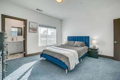 a bedroom with a blue bed and a window at Fully Updated! Prime Riverside Spot Near Dtwn in Riverside