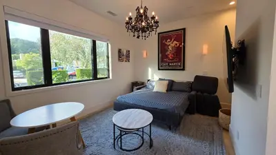 a living room with a couch and a bed and a table at Modern Studio with Kitchen Parking Near Beverly Hills and Culver City in Los Angeles