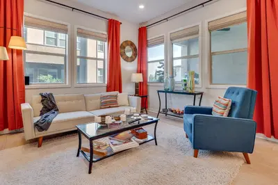 a living room with a couch and two chairs at 12 Mi to DTLA! Multi-Level Charmer with Pool Access in Montebello
