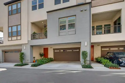 a large apartment building with a parking lot at 12 Mi to DTLA! Multi-Level Charmer with Pool Access in Montebello