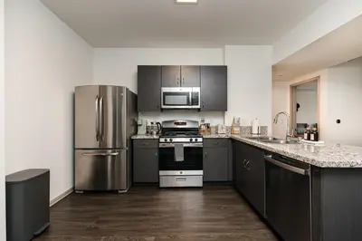 a kitchen with stainless steel appliances and wooden floors at Spacious 2bedroom in Hollywood with Parking Gym Pool in Los Angeles