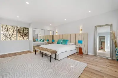 a white bedroom with a bed and a rug at The Sinatra House- Fully Furnished! in Los Angeles