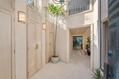 a hallway of a house with a potted plant at The Sinatra House- Fully Furnished! in Los Angeles