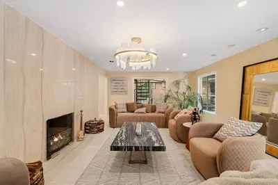 a living room with couches and a fireplace at The Sinatra House- Fully Furnished! in Los Angeles