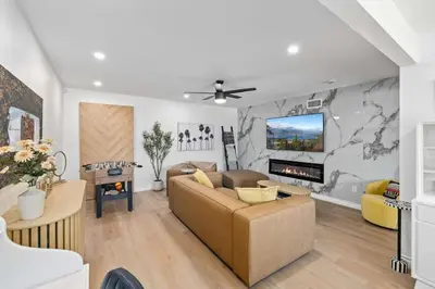 a living room with a couch and a tv at Private 3BR Home - Hot Tub, Yard, Arcade & Parking in Simi Valley