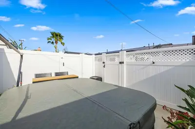 a patio with a table and a white fence at Private 3BR Home - Hot Tub, Yard, Arcade & Parking in Simi Valley