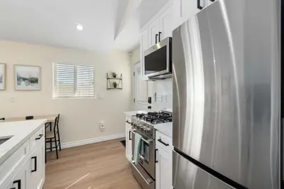 a kitchen with a stainless steel refrigerator and a stove at Luxury 1BR Suite Kitchen, Fireplace, Laundry, BBQ in Simi Valley